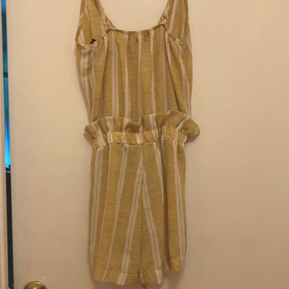 A stripped romper from See You Monday with a flare and tie at the waist.